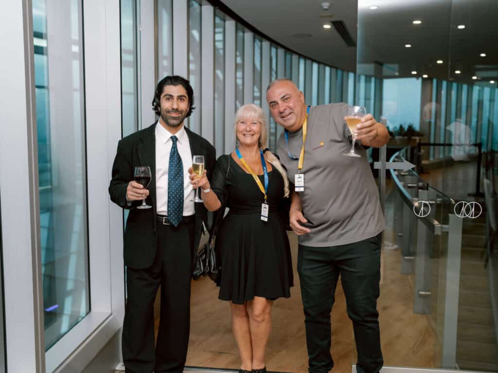 Business professionals enjoying drinks at Gold Coast live market event.